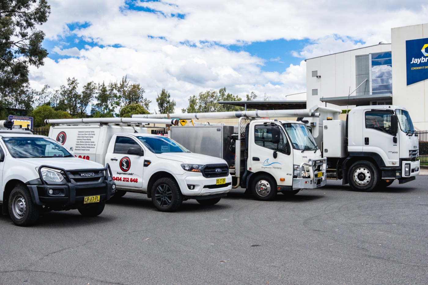 Service utes and trucks from a client fleet parked at a business park