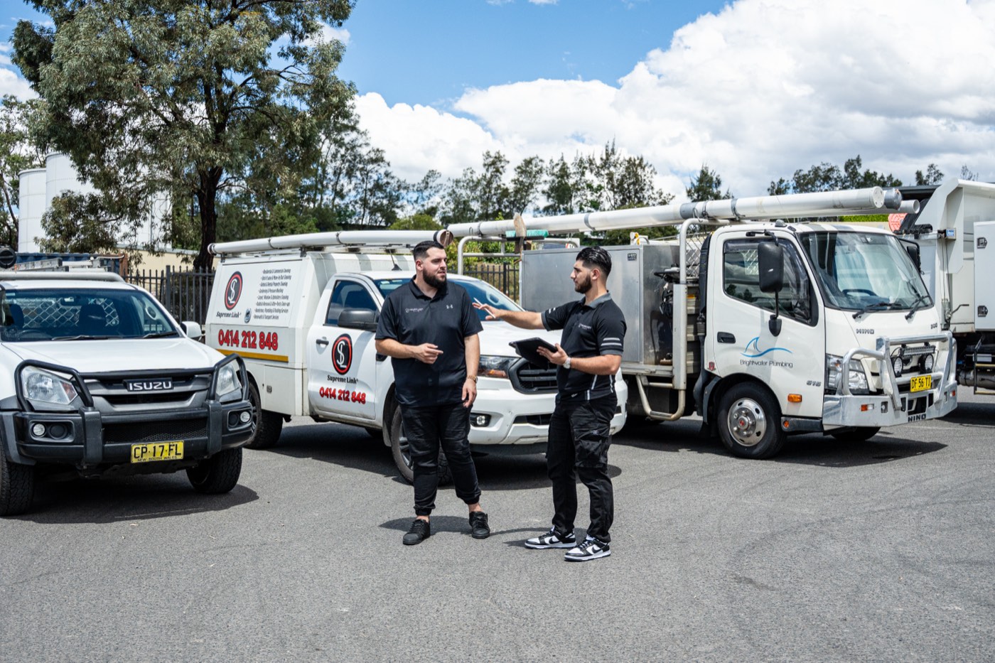 Two Your Fleet Elite staff reviewing a client fleet of service utes and trucks
